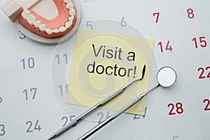 Dental health and teethcare concept. Dentist appointment in calendar and professional dental tools.