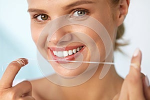 Dental Hygiene. Beautiful Woman Flossing Healthy White Teeth