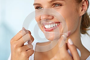 Dental Hygiene. Beautiful Woman Flossing Healthy White Teeth