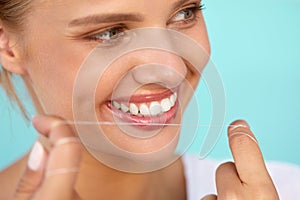 Dental Hygiene. Beautiful Woman Flossing Healthy White Teeth