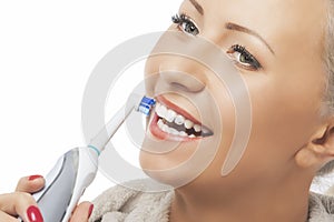 Dental Hygiene Concept:Caucasian Woman Face Closeup Brushing Her