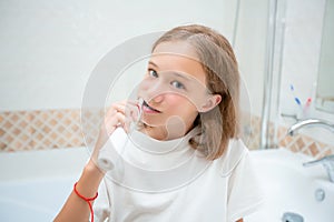 Dental hygiene. Happy little blonde girl brushing her teeth. Healthy concept