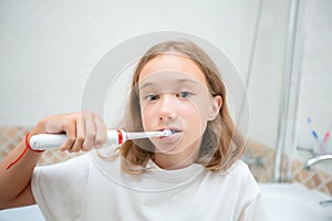 Dental hygiene. Happy little blonde girl brushing her teeth. Healthy concept