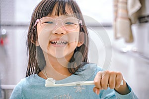 Dental hygiene. happy little girl brushing her teeth.Little girl brushing teeth in bath