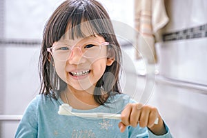 Dental hygiene. happy little girl brushing her teeth.Little girl brushing teeth in bath