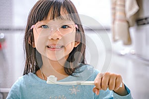 Dental hygiene. happy little girl brushing her teeth.Little girl brushing teeth in bath