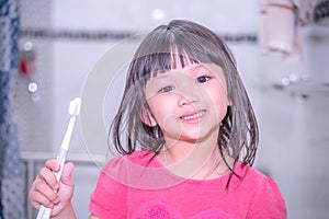 Dental hygiene. happy little girl brushing her teeth.Little girl brushing teeth in bath