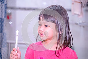 Dental hygiene. happy little girl brushing her teeth.Little girl brushing teeth in bath