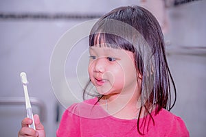 Dental hygiene. happy little girl brushing her teeth.Little girl brushing teeth in bath