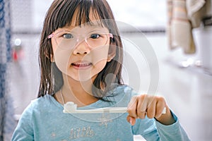 Dental hygiene. happy little girl brushing her teeth.Little girl brushing teeth in bath
