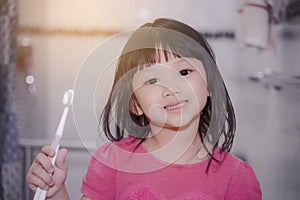 Dental hygiene. happy little girl brushing her teeth.Little girl brushing teeth in bath.