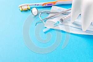 Dental hygiene and health concept. Dentist tools or instruments dental explorer, probe, dental mirror, syringe, white tooth model