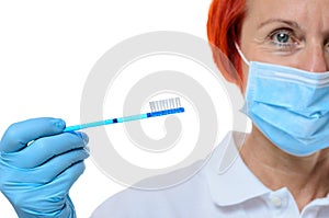 Dental hygienist in red hair with toothbrush photo