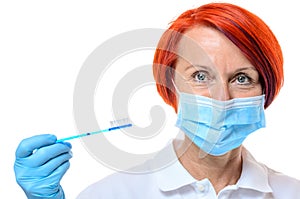 Dental hygienist in red hair with toothbrush