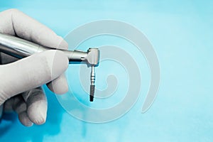 Dental implant in the hands of a dentist Dental prosthesis ready for surgery.