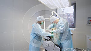 Dental implant surgery. Oral surgeon and assistant treating root canals in the modern dental clinic. Surgery operation