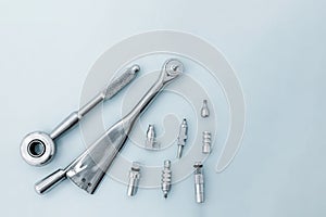 Dental implantation tools: reversible key, torque wrench on a blue background