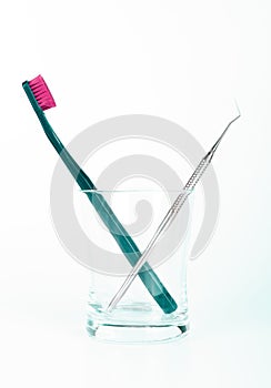 Dental instrument and tooth brush in glass