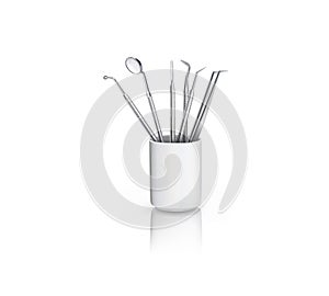 Dental instruments in ceramic cup with reflection