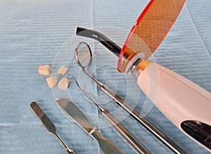 Dental instruments and dentures lying on sterile medical napkin in clinic