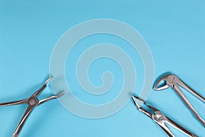 Dental instruments in the range for dental treatment on a blue background.