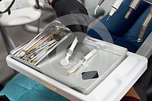 Dental instruments and x-ray shot on a silver tray in a dental clinic