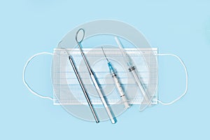 Dental instruments and syringes on a surgery mask