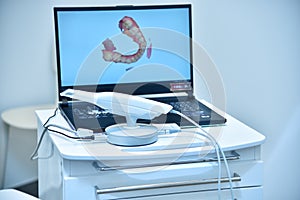 Dental intraoral 3d scanner and laptop on table