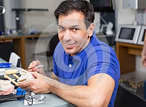 Dental lab technician appying porcelain