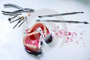 Dental laboratory. Full denture with toolfor make denture in technician workplace.