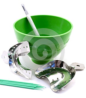 Dental metal impression trays, dental green flask, spatula, pins isolated