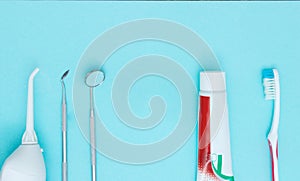 Dental Metal medical dentistry equipment tools, toothbrush and toothpaste dental care on blue background