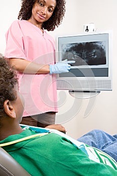 Dental nurse showing patient x ray