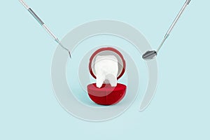 Dental offers, free dental treatment. Dental care concept. Top view. Tooth model in gift box on blue background. Creative medical