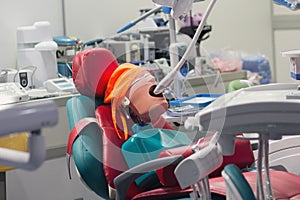 Dental office with a chair. Medical equipment and mannequin