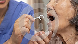 Dental and oral health , Caregiver take care asian elderly woman while brush teeth