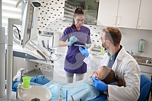 Dental ordination with patient in dental chair with doctor and a