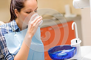 Dental patient woman wash mouth after treatment