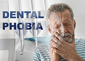 Dental phobia. Mature man suffering from toothache