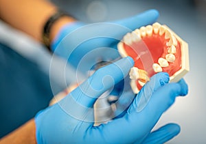 Dental prosthesis, dentures, prosthetics work. Prosthetics hands while working on the denture