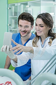 Dental prosthesis, dentures, prosthetics work. Prosthetics hands while working on the denture, false teeth, a study and a table wi