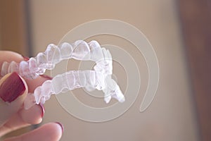 Invisible dental orthodontics held by a woman photo