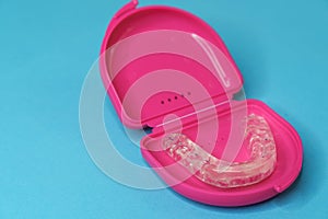 dental retainer teeth in a pink boxset