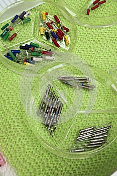 Dental root canal treatment tools used in stomatology placed in shallow medical glass organizers