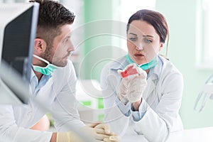 Dental students while working on the denture, false teeth.