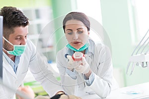 Dental students while working on the denture, false teeth.