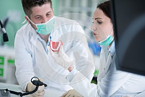 Dental students while working on the denture, false teeth.