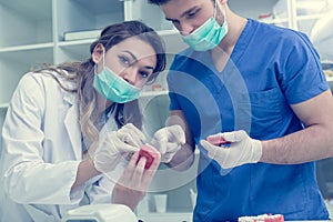 Dental students while working on the denture, false teeth.