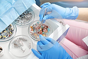 Dental surgeon lifting a single prophy cup from tray