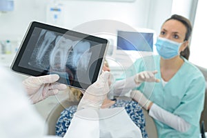 Dental team checking teeth x ray patient